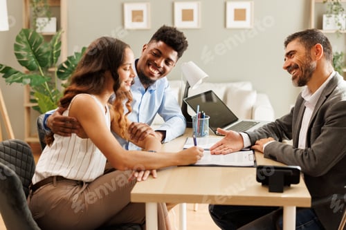 Preview: Young couple signing a contract with their financial advisor