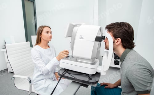Preview: Optometrist using autorefractor check patient vision. Eye exam of adult people