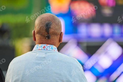 Preview: Back view of adult man head with ukrainian chub haircut at outdoor party, rear view of man head