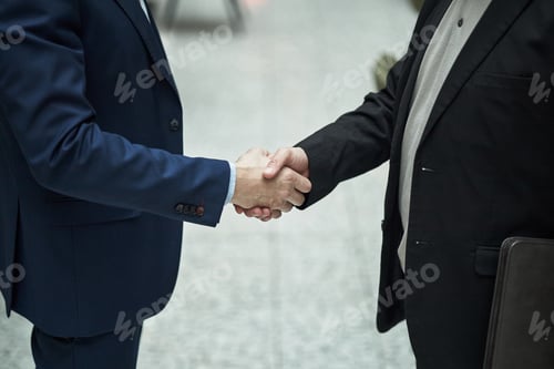 Preview: Businessmen Shaking Hands after Important Meeting in Office Lobby