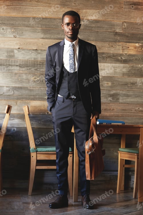 Preview: Success and career concept. Full-length shot of successful African entrepreneur in formal wear, hold