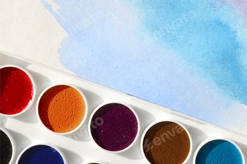 Preview: Watercolor Paints in Palette with Blue Wash Background