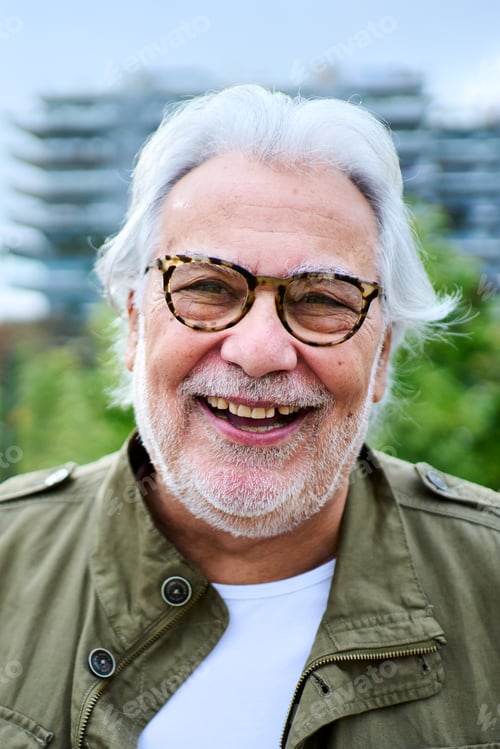 Preview: Portrait of happy mature Caucasian senior man standing outdoors with unfocused background garden.