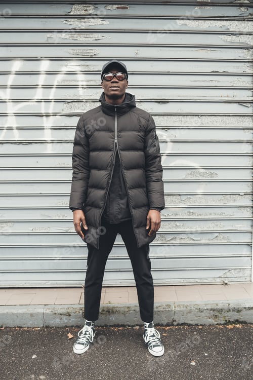 Preview: portrait of young african man standing in the street