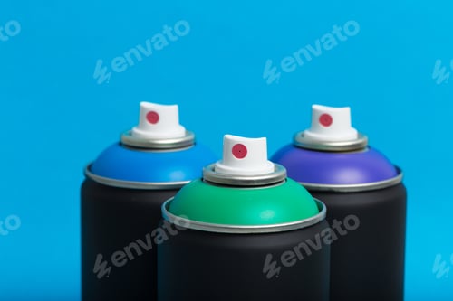 Preview: Colorful spray cans display vibrant hues against a blue backdrop for creative projects