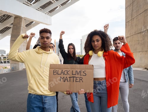 Preview: Group of diverse young people protesting against racism holding a sign that says black lives matter