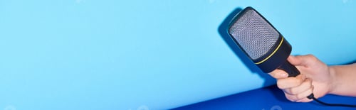 Preview: cropped view of woman holding microphone on colorful background