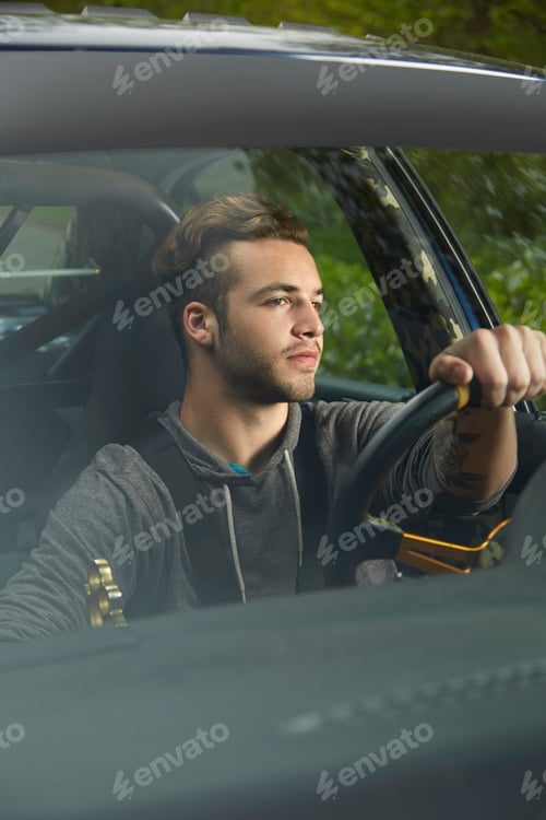 Preview: Portrait of man driving looking through windscreen
