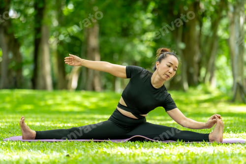Preview: A woman is doing a yoga pose in a park