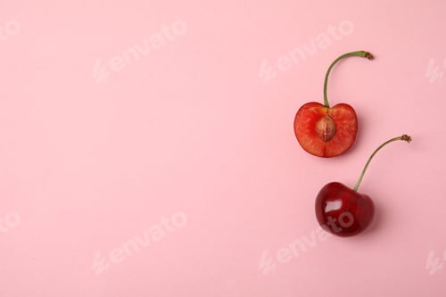 Preview: Cut and whole sweet cherries on pink background, top view. Space for text