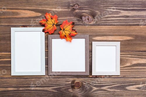 Preview: mock up three empty photo frame on a brown wooden background and orange maple leaves