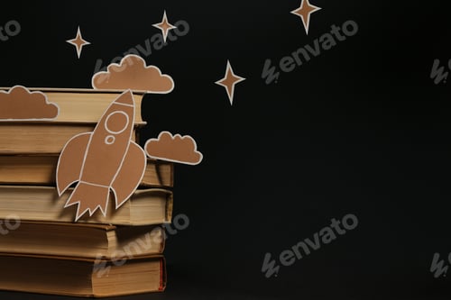 Preview: Open Books on a Black Background with Paper Silhouettes Depicting Their Stories