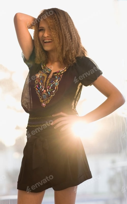 Preview: Teenage girl smiling outdoors