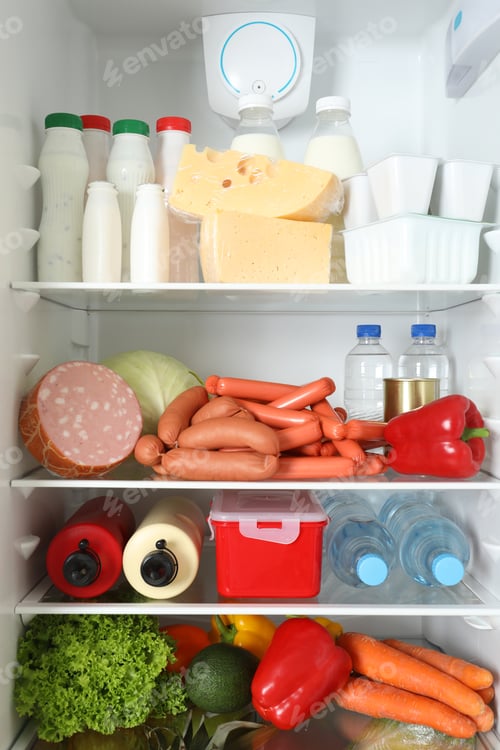 Preview: Open refrigerator with many different products, closeup