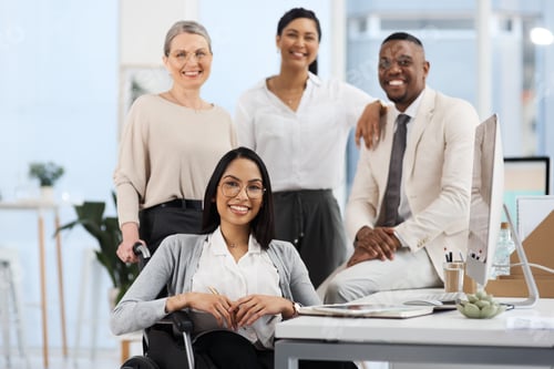 Preview: Cropped portrait of a group of diverse businesspeople smiling while gathered in their office