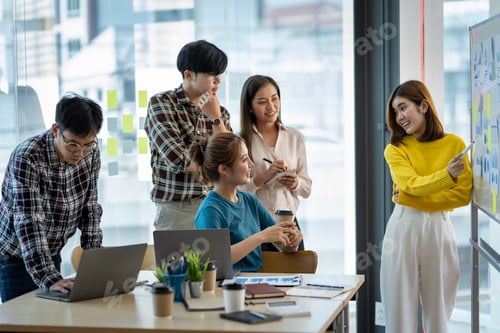 Preview: A group of young modern Asians in smart casual wear are having a brainstorming meeting while sitting