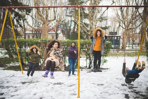 Preview: young women having fun on the swing outdoor in winter day