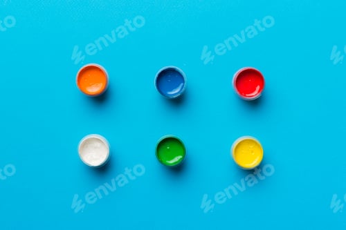 Preview: jars with gouache of different colors on Colored background. hobby painting