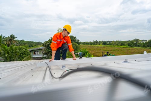 Preview: technician lifting a photovoltaic panel during installation