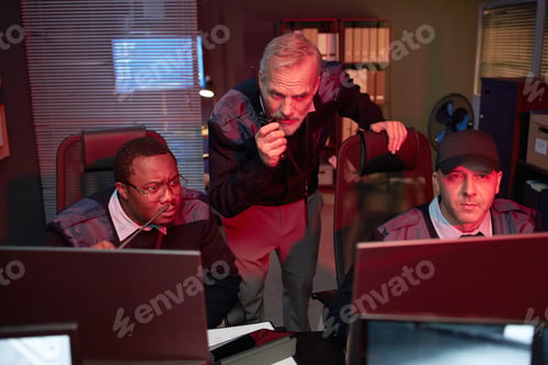 Preview: Middle Aged Multiethnic Security Officers Monitoring Surveillance Screens