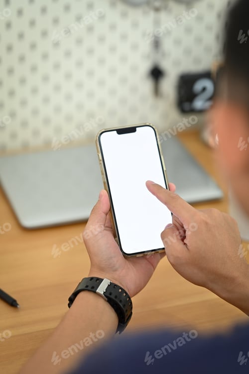 Preview: View over shoulder man hand texting or messaging online on smartphone