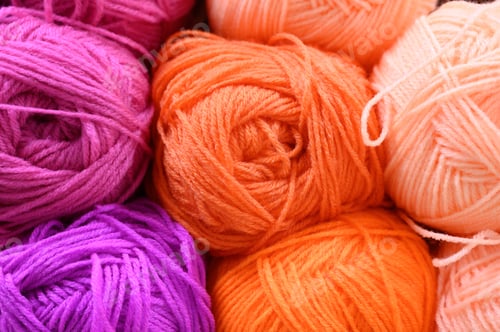 Preview: background of rows skeins of fluffy wool yarn for knitting different bright colors