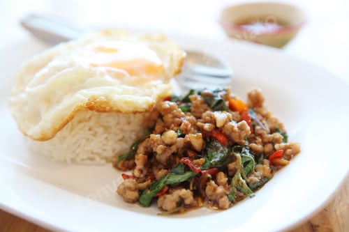 Preview: Stir Fried Pork And Basil With Rice And Egg On Wood Background Thai Food