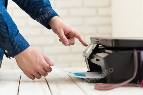 Preview: Man's hand making copies. Working with printer