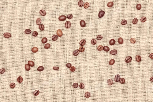 Preview: Lots Of Coffee Seeds Lie On Linen Fabric