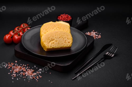 Preview: Delicious porous yellow cheese cut in large pieces on a ceramic plate