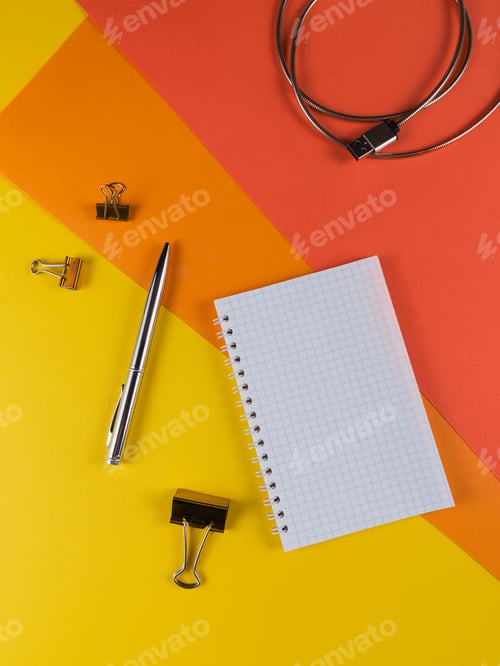 Preview: Yellow office desk table with blank notebook and other office supplies