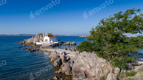 Preview: Little church of Agios Isidoros in the sea over the rocks, Chios island, Greece.