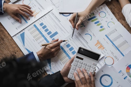 Preview: Business People Meeting using laptop computer,calculator,notebook,stock market chart paper for