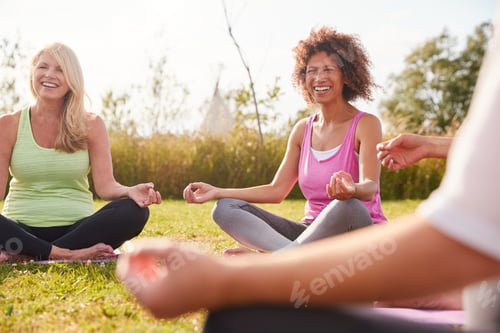 Preview: Group Of Mature Men And Women In Class At Outdoor Yoga Retreat Sitting Circle Meditating