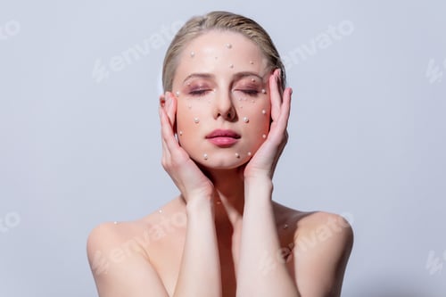 Preview: beautiful girl with pearls on the skin of the face
