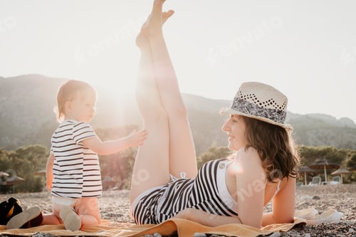 Preview: Mother and Toddler Enjoying Sunny Day at Beach