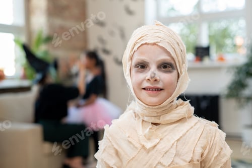 Preview: Portrait of smiling boy wrapped up into bandages like mummy
