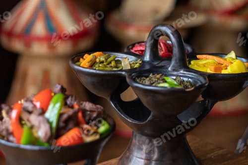 Preview: Selective focus shot of delicious Ethiopian food with fresh vegetables on a wooden table