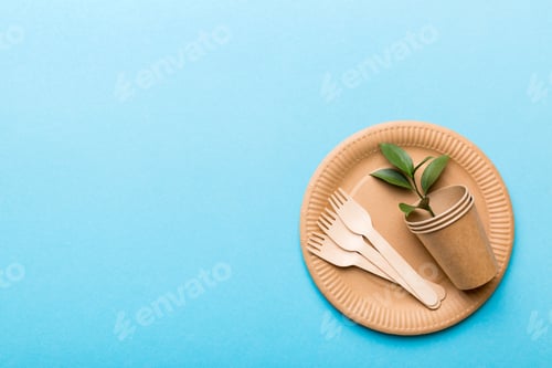 Preview: set of empty reusable disposable eco-friendly plates, cups, utensils on light white colored table