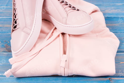 Preview: Womanly sweatshirt or hoodie and leather shoes on old boards