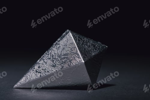 Preview: close-up view of faceted piece of silver mineral on black