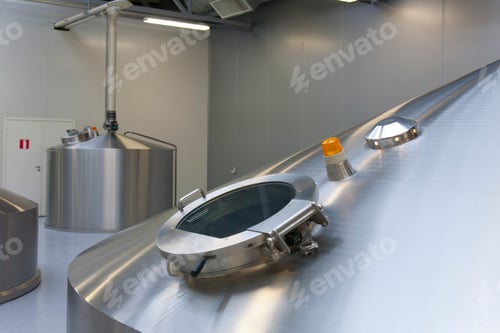 Preview: Interior of brewery, large steel storage tanks for brewing beer, inspection hatch