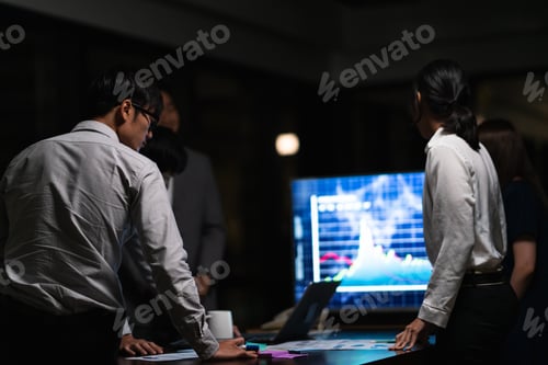 Preview: Millennial Asia businessmen and businesswomen meeting brainstorming ideas in night office.