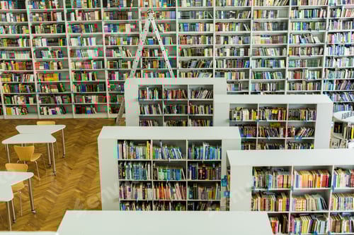 Preview: racks with collection of books near wooden desks and chairs in library