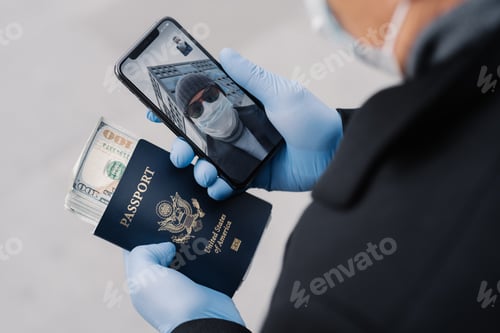 Preview: Unknown man holds mobile phone, has video conference with friend.