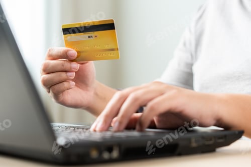 Preview: Woman using laptop for online shopping by credit card. Cashless payment using laptop.
