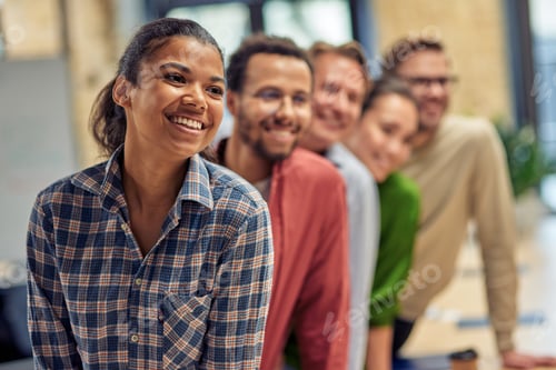 Preview: Successful startup team. Group of young happy multiethnic colleagues smiling while posing in the