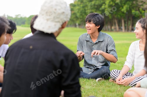 Preview: Happy young group of friends having fun together at the park