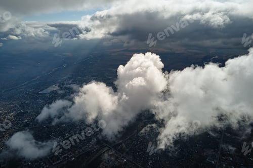 Preview: Aerial view from airplane window at high altitude of distant city