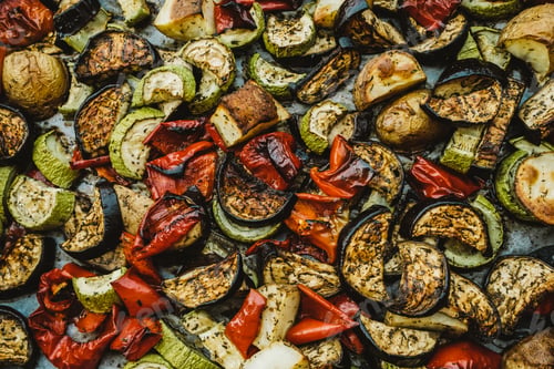 Preview: Top view of Baked vegetables: tomatoes, eggplants, peppers and zucchini. Background